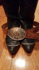 Cowboy boots and a belt buckle.