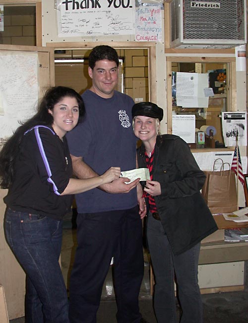 Vinyl Queen and Mistress Nadine donate a check to a local firehouse after 9/11.